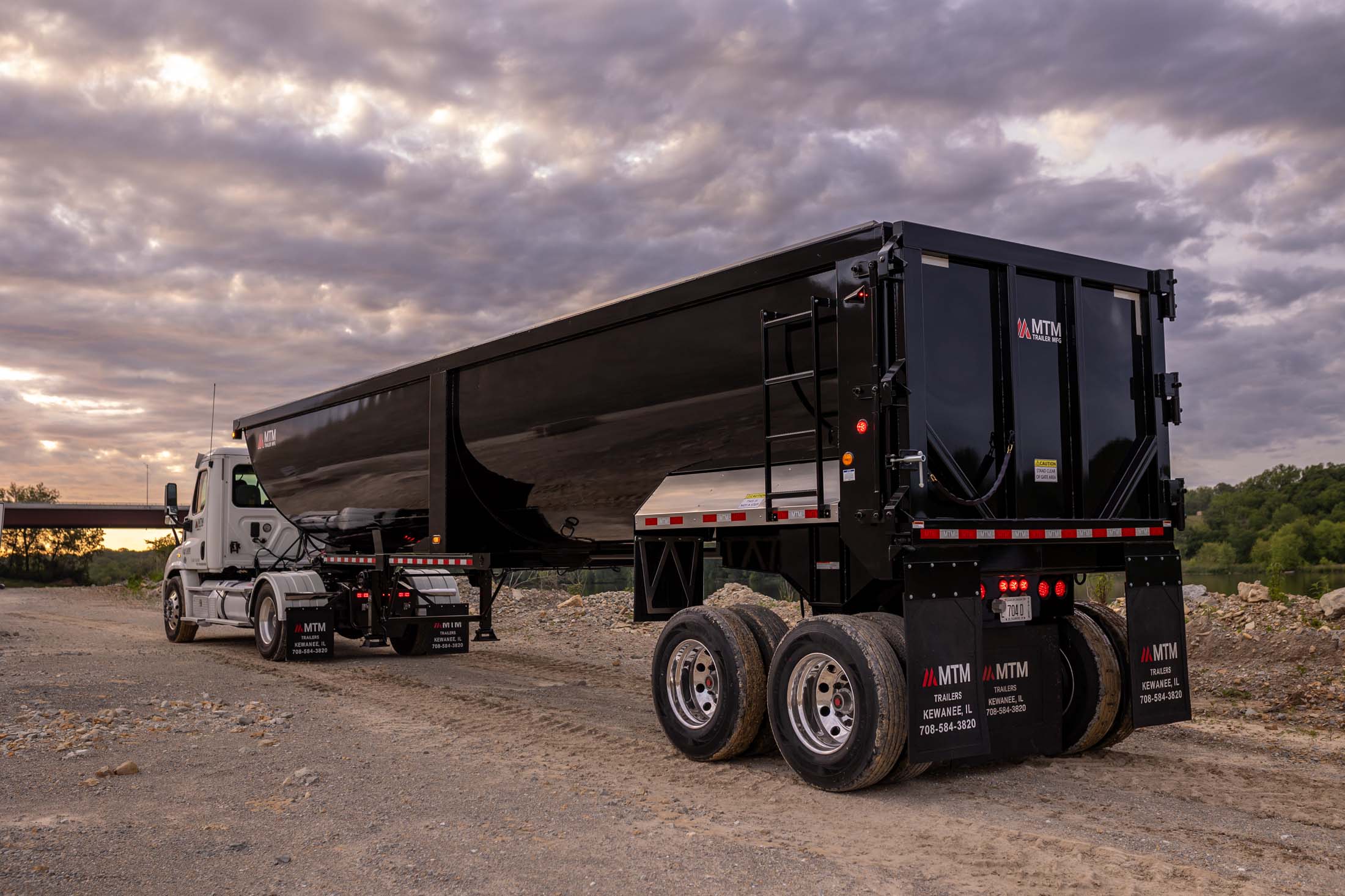 black 40' end-dump trailer in a quarry